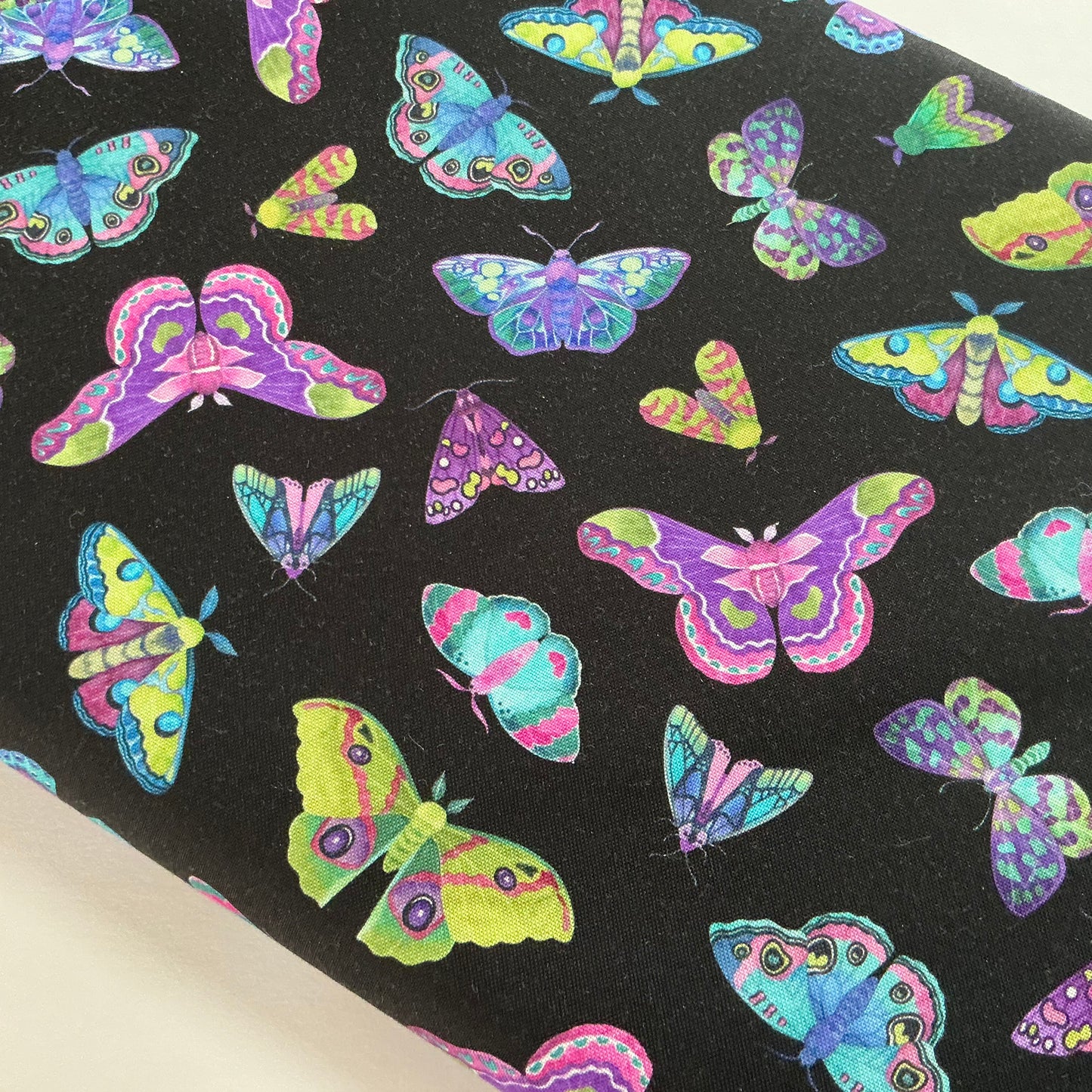 Multicoloured Moths Scattered on Black - Nightshade